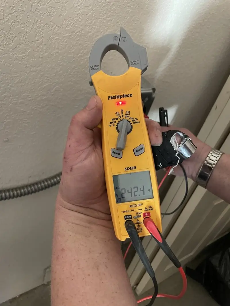 Voltage testing with clamp meter during Electrical Installation Services in Ilchester
